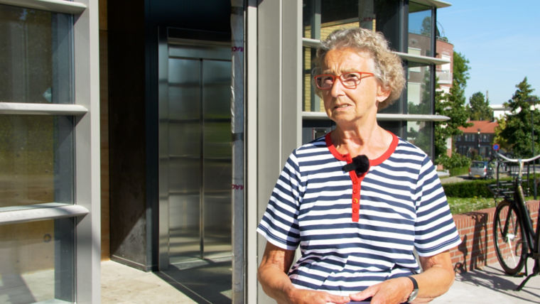 Resident of the Leerdam apartment block in front of the new elevator.